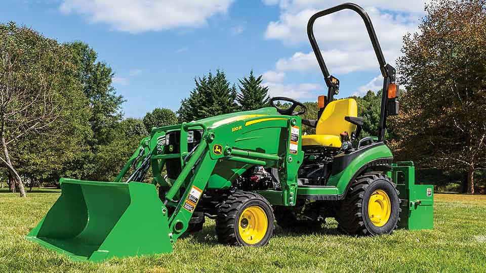 1025R with loader in grassy field 1025R with loader in grassy field