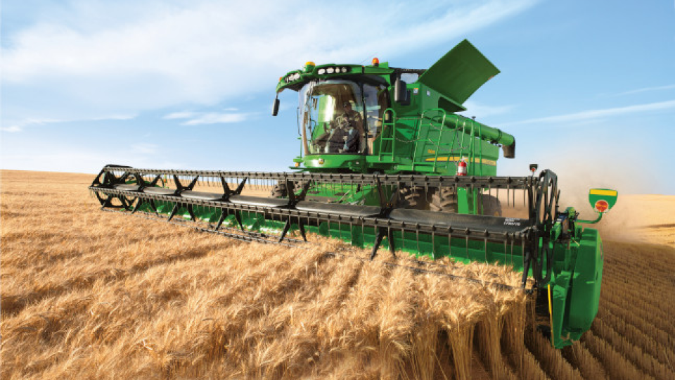 john deere combine in wheat field