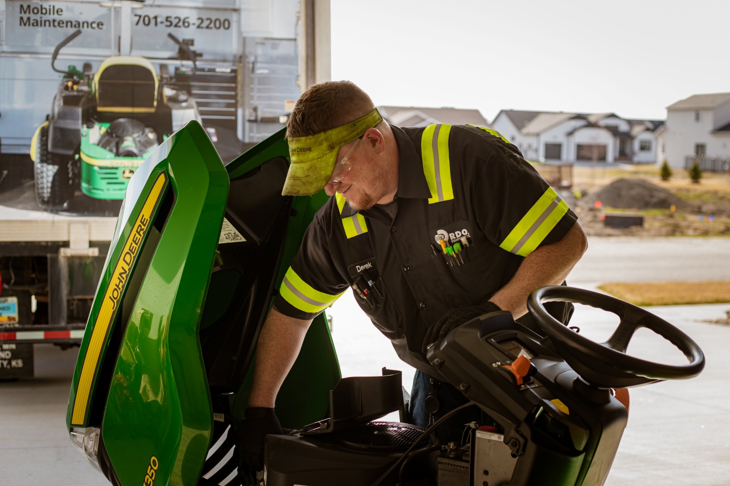 Technician working on a mower