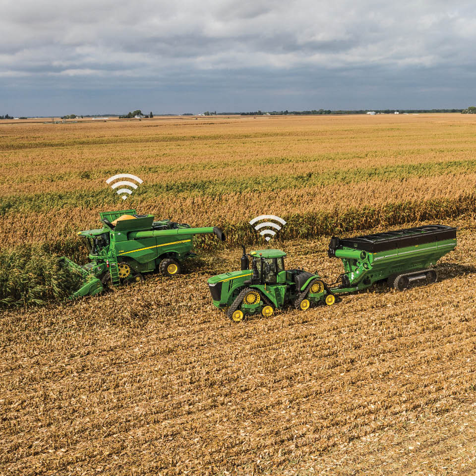 Wifi Image Above John Deere Combine and John Deere Tractor Harvesting Corn