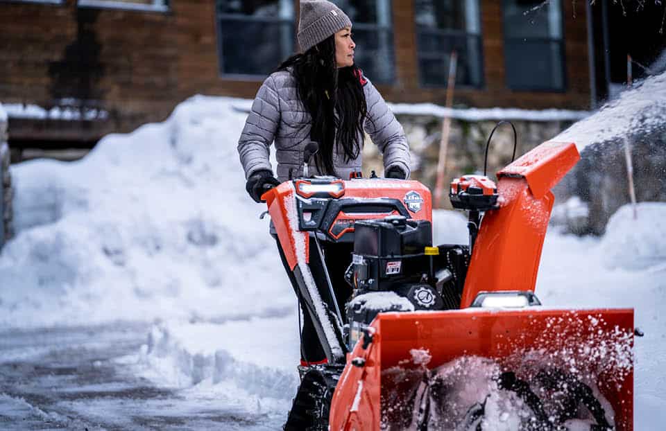 Airens snow blower being used to clear sidewalk