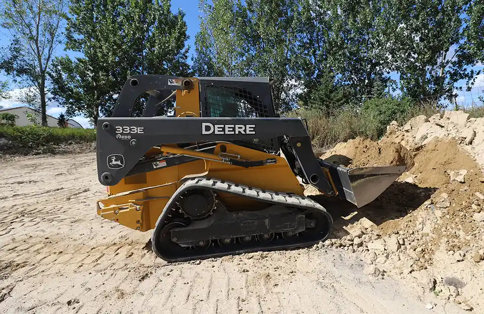 John Deere Compact Track Loader loading sand.