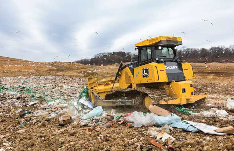 John Deere 850L Dozer working on landfill
