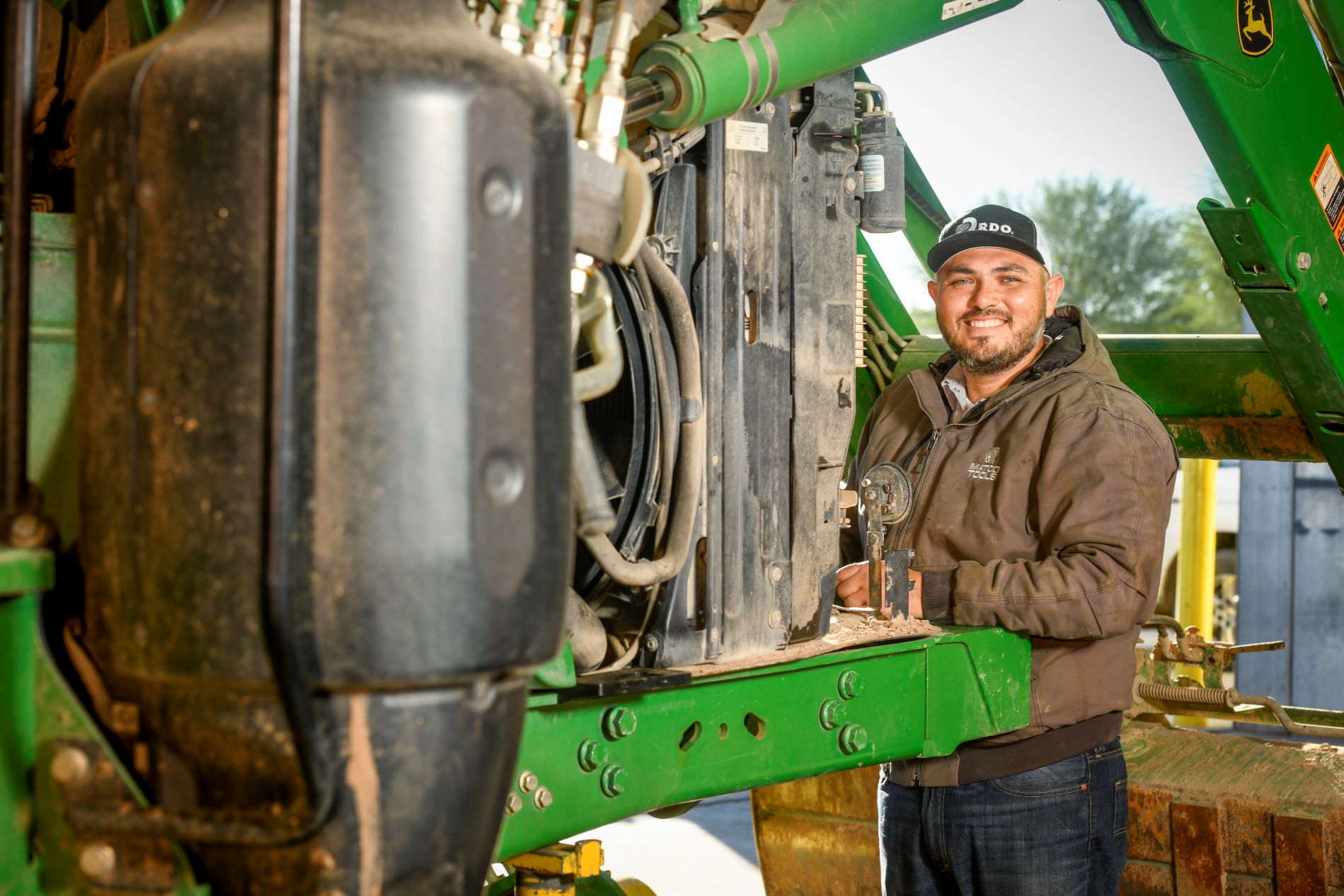 Service technician working on a tractor