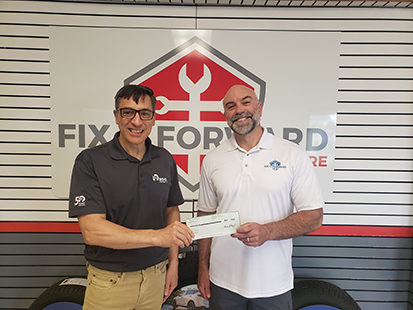 R.D. Offutt Company Director of Analytics Howard Fulks presents Fix It Forward Co-founder Jeremy Jensen with Community Builder Grant during June 2022.