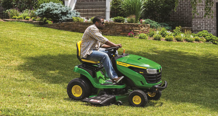John Deere S140 lawn tractor mowing lawn.