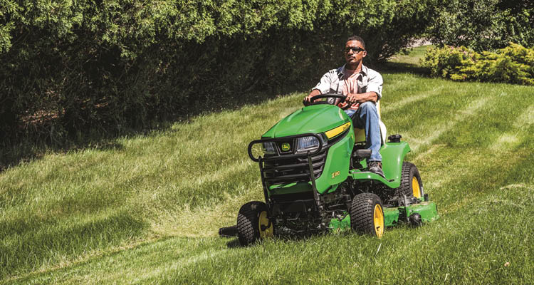 John Deere X590 lawn tractor mowing a lawn