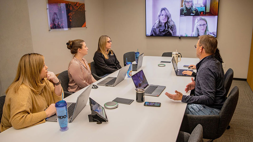 field support employees in conference room talking