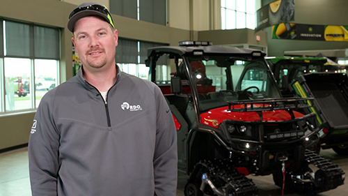 Carson Laney, Product Specialist with RDO Equipment Co. and Volunteer firefighter, stands in front of the Fire Gator 