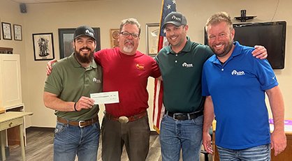 Mason Davis, Parts Manager, RDO Equipment Co.— Kalispell, MT, and other RDO team members, presents Timothy Norton, Treasurer and Flathead Marines, Inc. founding board member, with a Community Grant from the Offutt Family Foundation. 