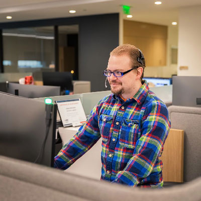 field support team member talking on phone at desk