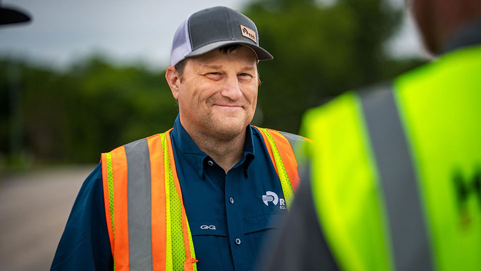 field technician smiling at job site