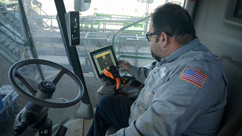 Heavy equipment coordinator in cab of tractor