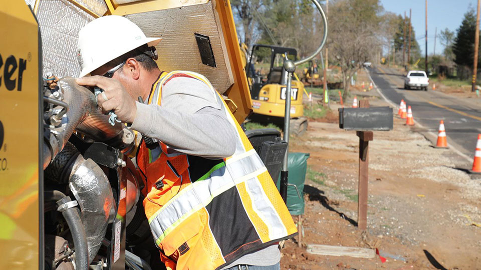 service technician leaning over vermeer equipment