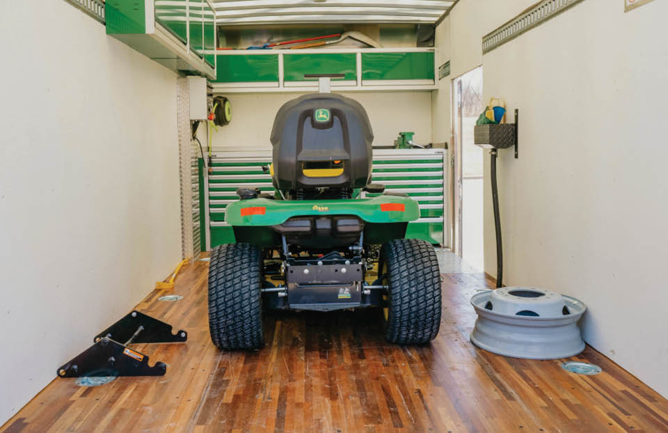 Certified technician working on a John Deere Z9 commercial mower.