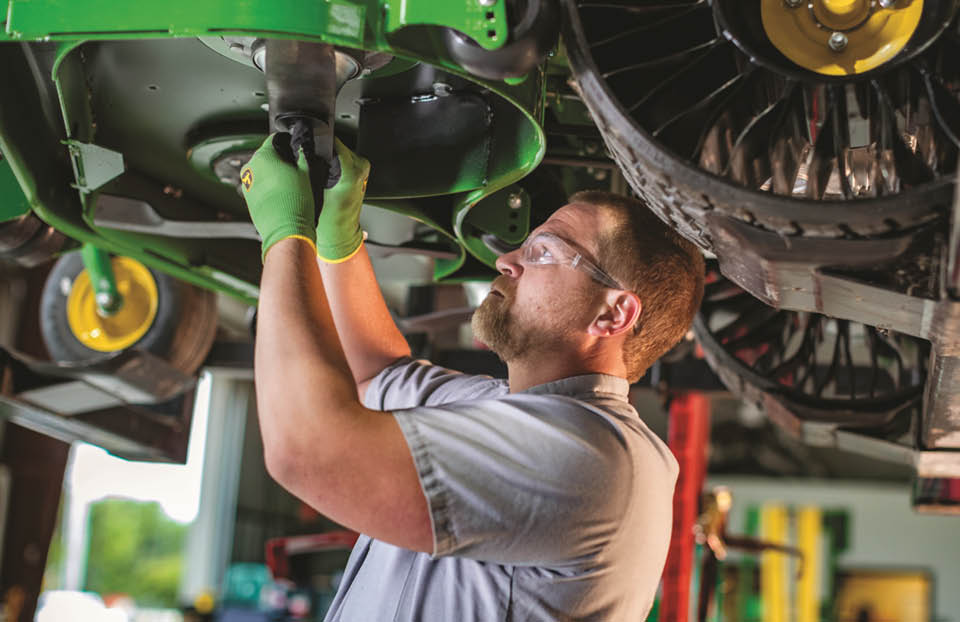 Technician working on a Z9 John Deere commercial mower.