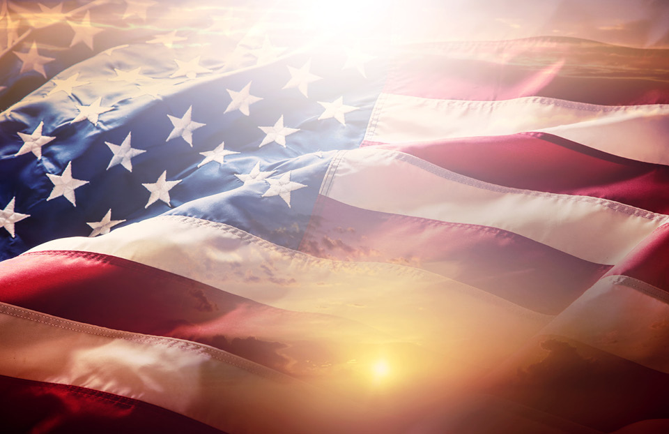 United States of America flag flying over sunset