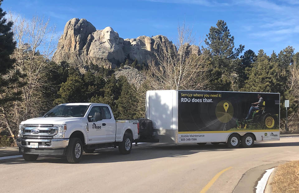 Rapid City Mobile Maintenance truck and trailer in front of Mount Rushmore.