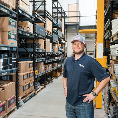 RDO parts specialist standing between shelves 