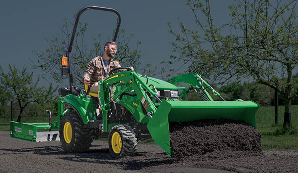 1023E John Deere sub-compact tractor with loader, bucket and land plane.