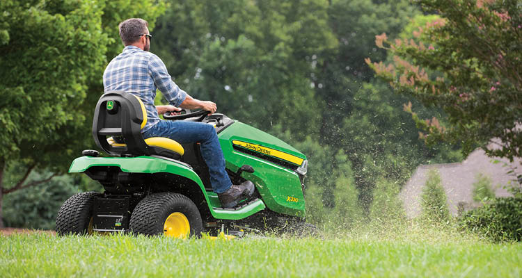 Man Driving John Deere X330 Riding Lawn Tractor