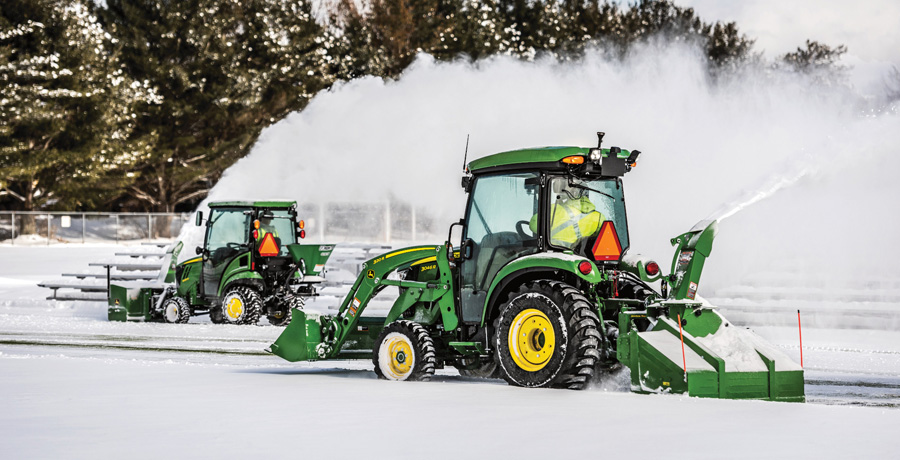 John Deere compact tractor with snow attachments.