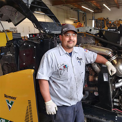 RDO service technician next to vermeer machinery
