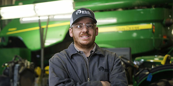 service technician in front of combine