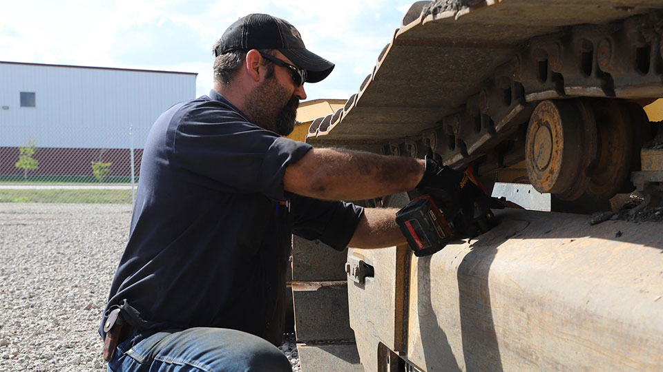 Field technician working on machinery