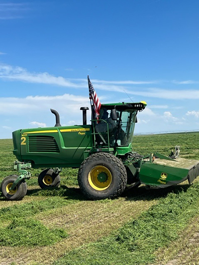 John Deere Windrower in a Northwest field 