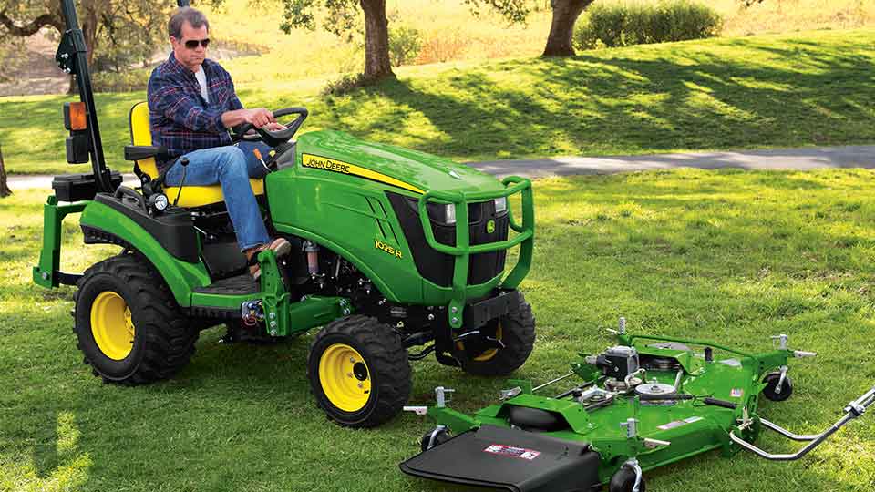 1025R driving over mower deck