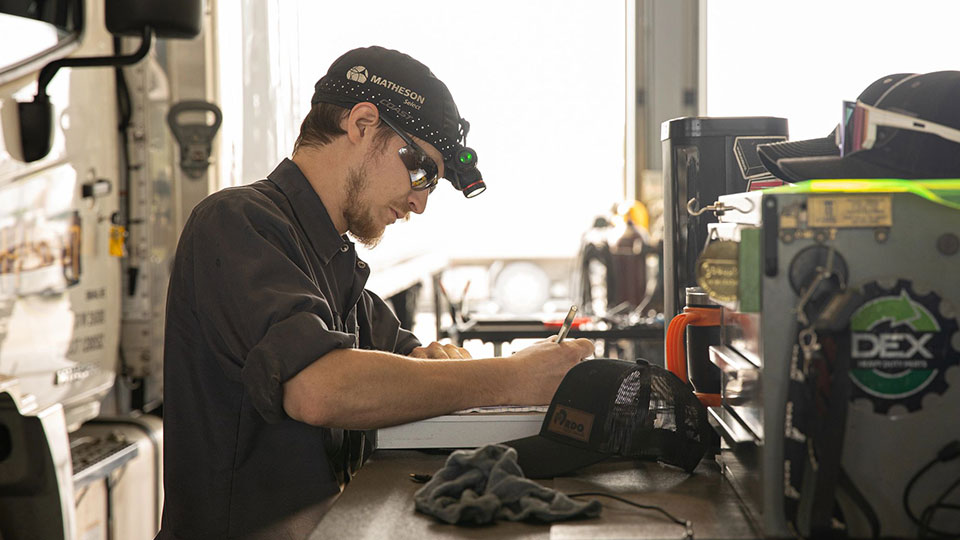 Mechanic taking notes at desk