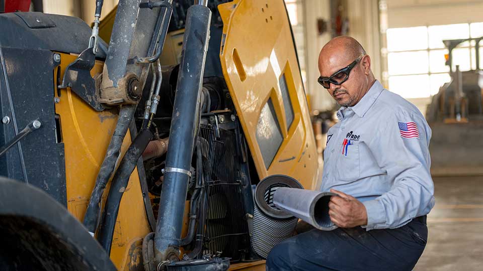 technician changing filter in machine