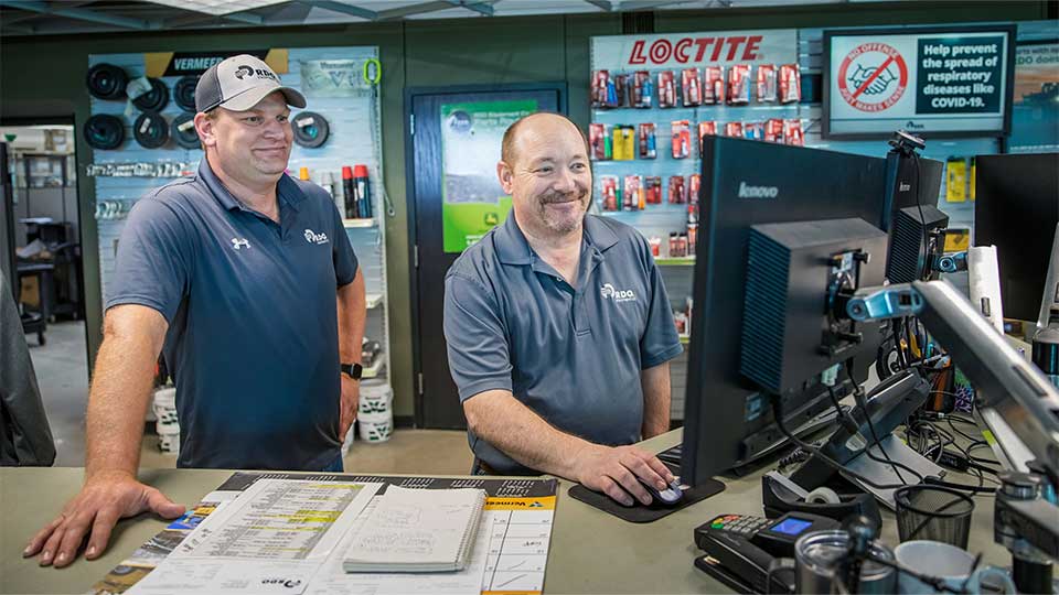 Parts manager helping parts specialist