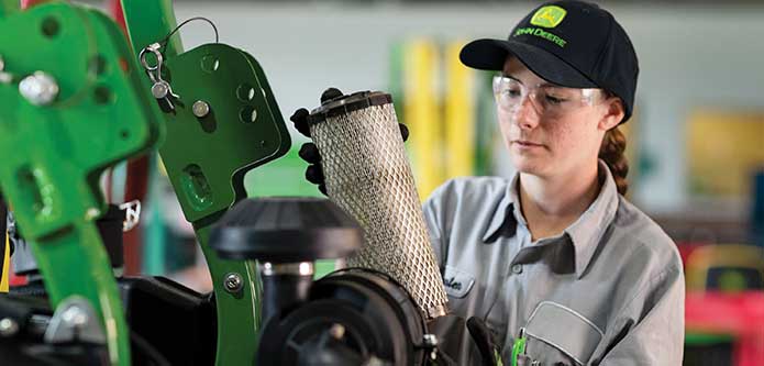 service technician repairing filter on machinery