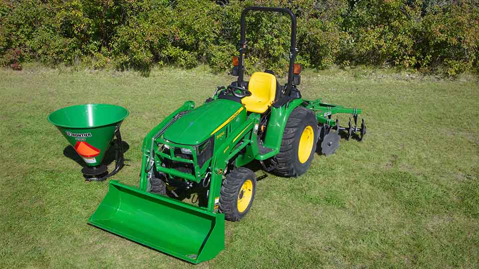 compact utility tractor on property with attachments
