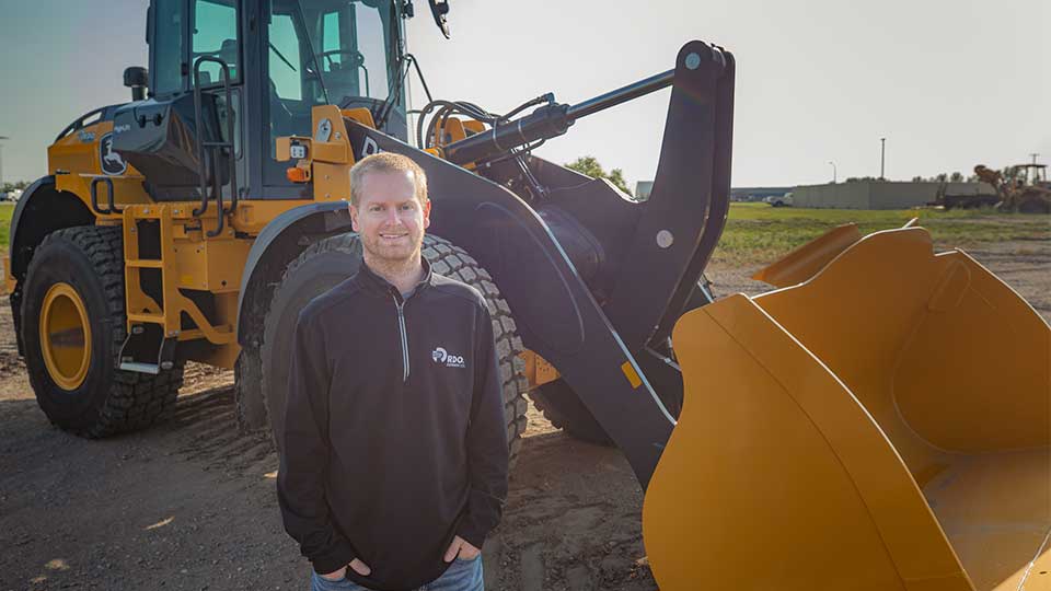 RDO Sales Professional in front of John Deere