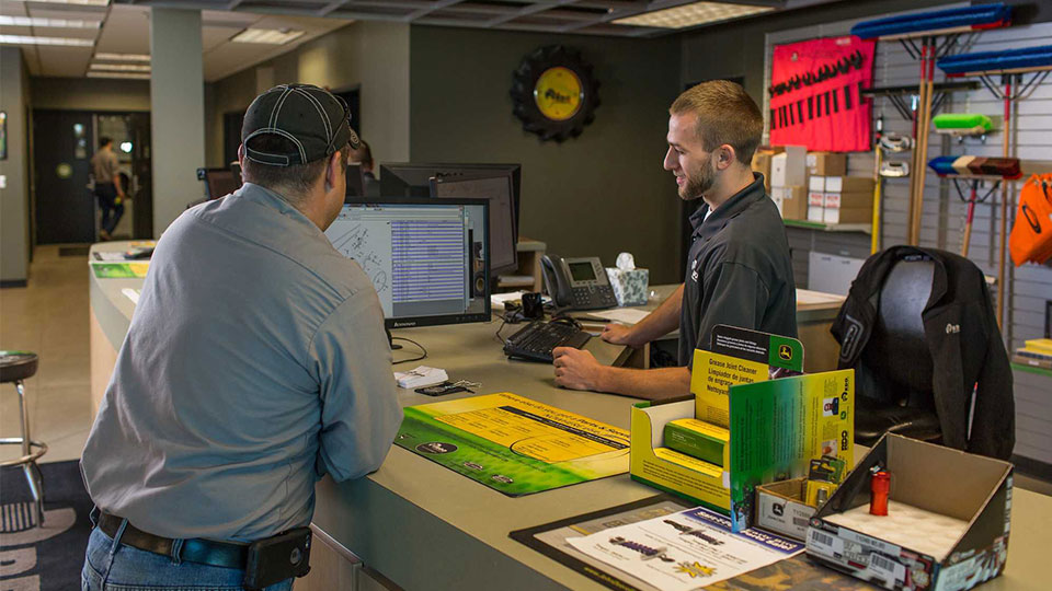 customer ordering parts from specialist at parts counter