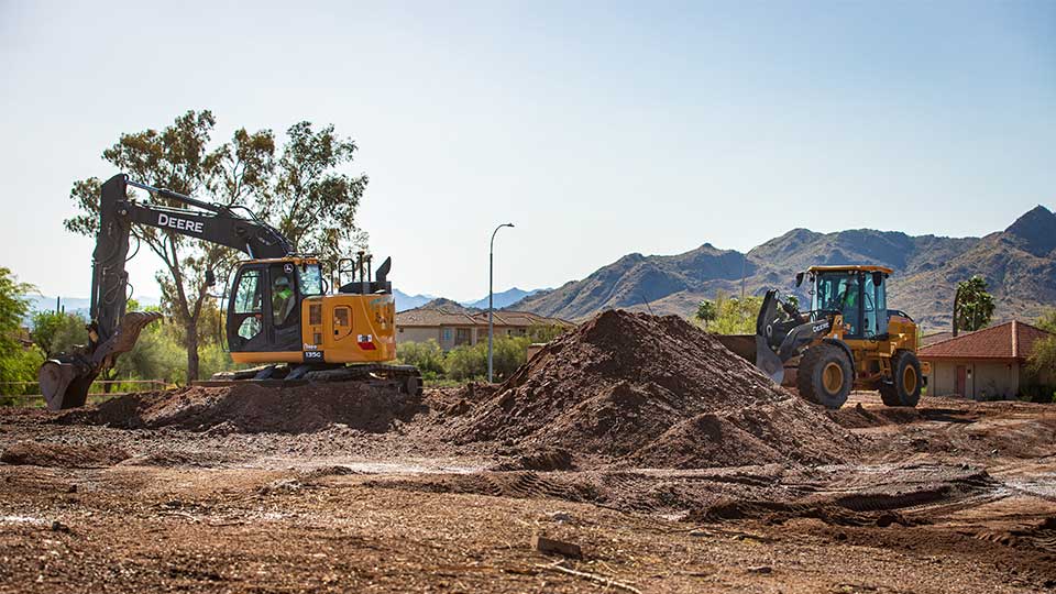 Bulldozer and excavator working on construction site