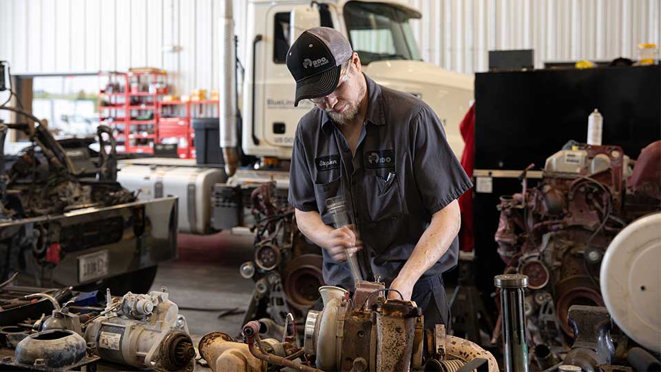 Semi Truck Diesel Mechanic working on engine