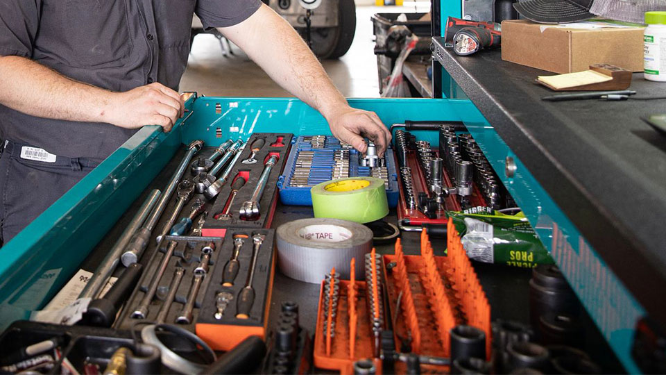 service technician handling tools in toolbox cabinet