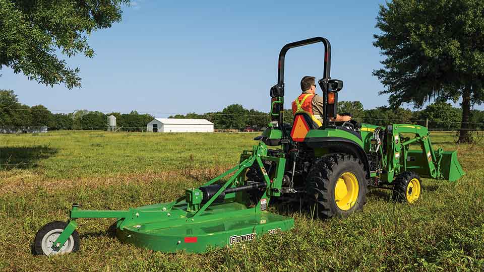 man mowing farm with 2032 tractor