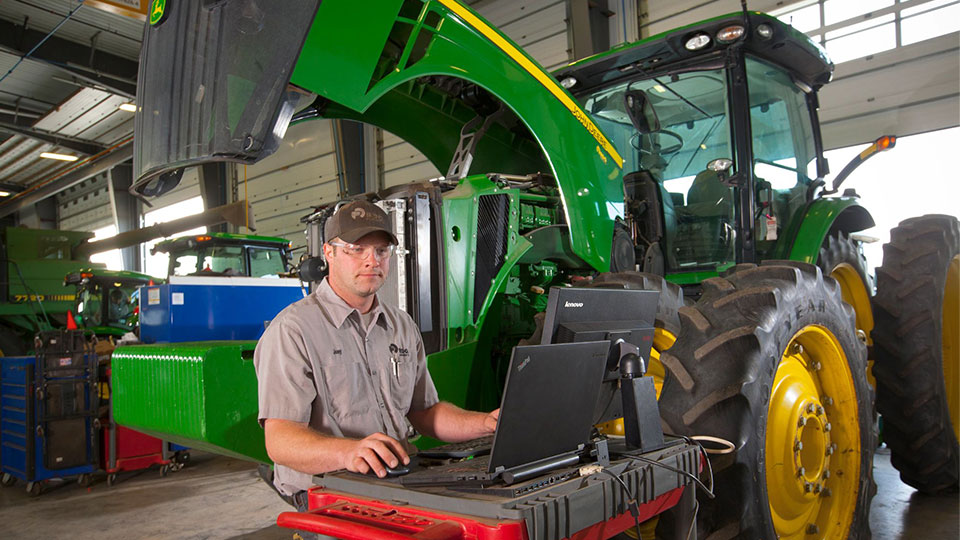 service technician behind desk in service shop