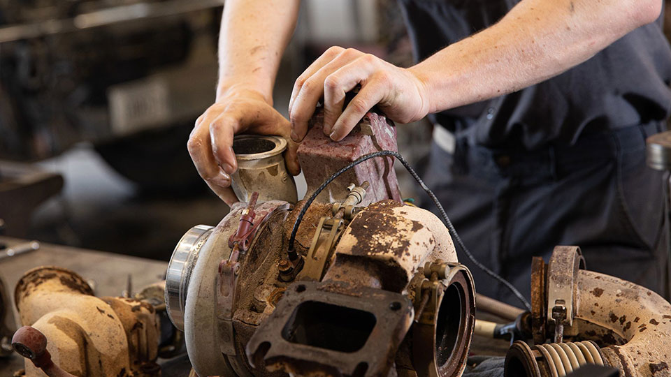 service technician hands on machine part