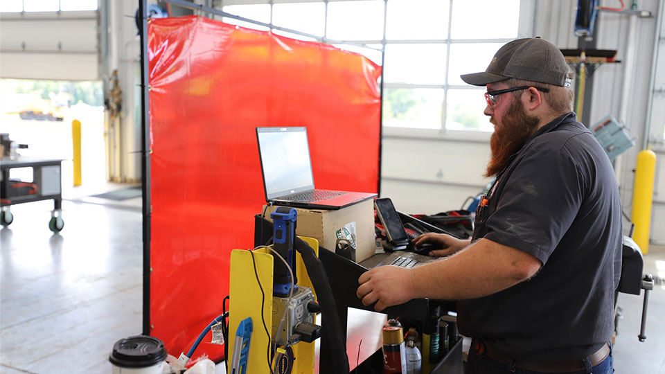 service technician standing at work area in shop