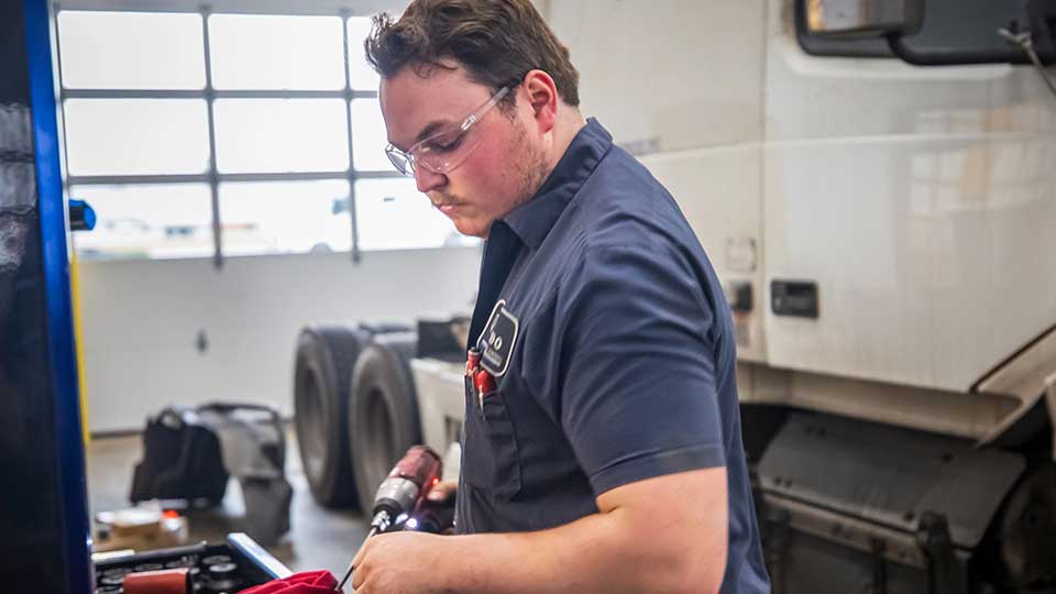 mechanic intern holding drill