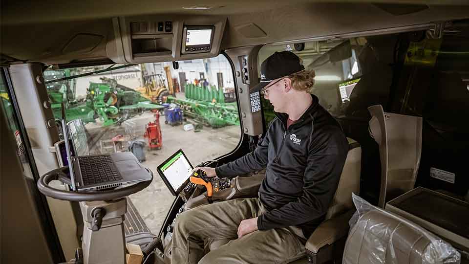 service technician working on tractor
