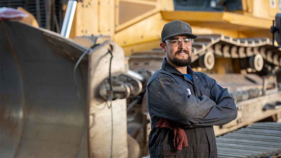 heavy equipment mechanic crossing arms