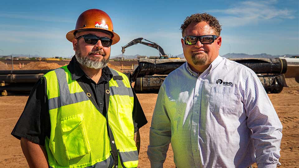 Heavy Equipment Operator with RDO Salesperson on Jobsite
