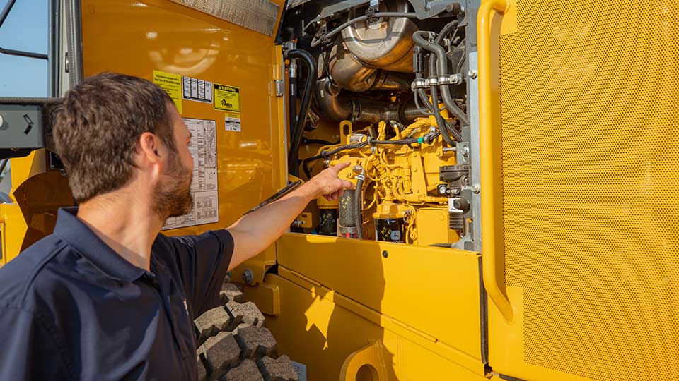 Technician inspecting a john deere engine